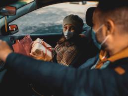 Family shopping Christmas gifts during COVID-19 pandemic. They wears a protective mask to protect from coronavirus, COVID-19, omicron