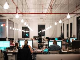 people sitting on office chairs in front of computers, office setup