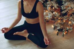 A woman practices yoga at Christmas, mental health, fitness, festive season