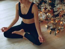 A woman practices yoga at Christmas, mental health, fitness, festive season