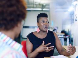 Unposed group of creative business people in an open concept office brainstorming their next project, BAME business women