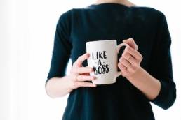 female leader holding mug which says like a boss, female founder, entrepreneur