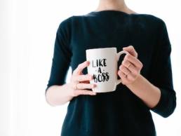 female leader holding mug which says like a boss, female founder, entrepreneur