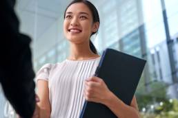 beautiful asian chinese business woman shaking hands in modern city work office, return to work, shaking hands, mother
