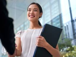 beautiful asian chinese business woman shaking hands in modern city work office, return to work, shaking hands, mother