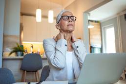 Cropped shot of a mature businesswoman looking stressed out while working in her office at home, menopause at work