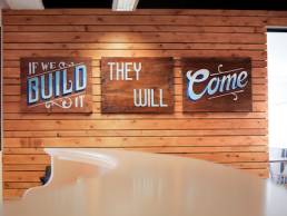 Taxi Studio, Image of an open plan office with signs saying 'If we build it, they will come'