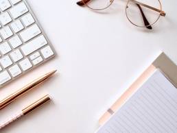 Laptop, pen and notepad on desk, working from home, PR