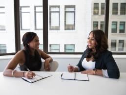Female mentors sitting at table, mentoring, women having a mentoring session