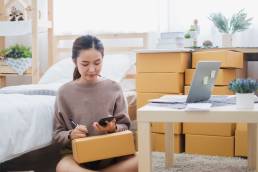 Young asian woman talking on the phone, female entrepreneur, running a business