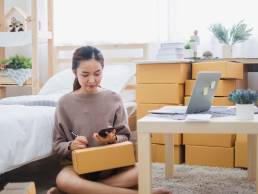 Young asian woman talking on the phone, female entrepreneur, running a business