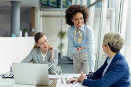 Female businesswoman talking to two colleagues during a meeting in office