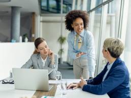 Female businesswoman talking to two colleagues during a meeting in office