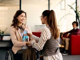 Happy employee receiving employee of the month badge