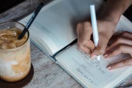 Person writing down sales strategy, hybrid working, entrepreneur