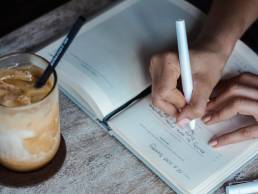 Person writing down sales strategy, hybrid working, entrepreneur