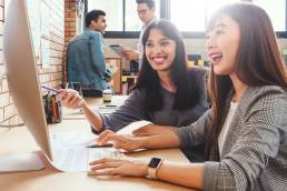 Happy businesspeople smiling while working together in office