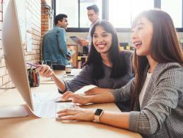 Happy businesspeople smiling while working together in office