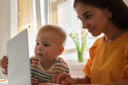 Working mother working from home with young baby