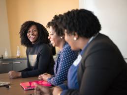 Smiling happy business women in conference room, women in finance