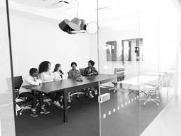 Group of women sitting in boardroom