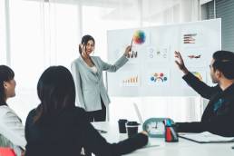 Woman presenting to team members, negotiating