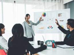 Woman presenting to team members, negotiating