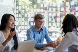 Group of coworkers taking part in thinking exercise during meeting