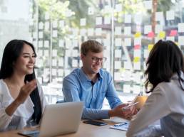 Group of coworkers taking part in thinking exercise during meeting