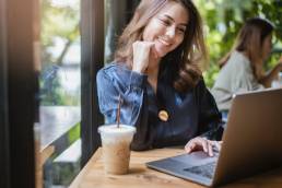 happy smiling woman working remotely, wellbeing
