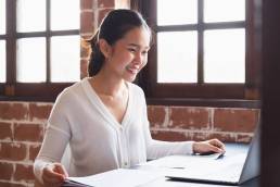 Smiling happy businesswoman working in office