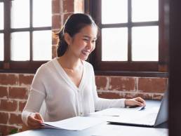 Smiling happy businesswoman working in office