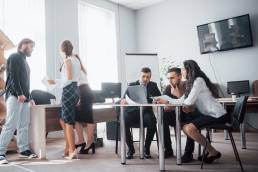 Group of colleagues in a meeting together, businesspeople, equity in the workplace