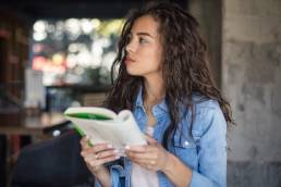 Woman standing reading book