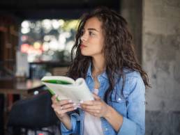 Woman standing reading book