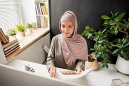 Businesswoman working at desk, making career moves