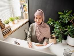 Businesswoman working at desk, making career moves