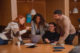 Happy team of co-workers in office, smiling employees