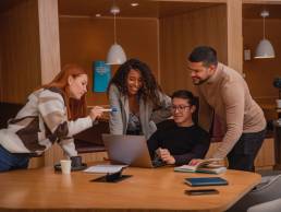 Happy team of co-workers in office, smiling employees