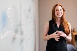 Happy professional woman presenting at work