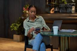 Businesswoman sitting at table, searching for employers, flexible working