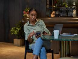 Businesswoman sitting at table, searching for employers, flexible working
