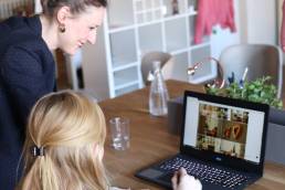 Photograph of two women working on a laptop