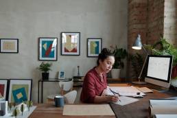 Woman working from home setting up a business, female entrepreneur