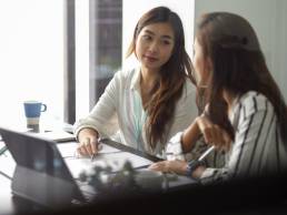 Female leader with colleague, leadership, mentoring, two businesswomen working together