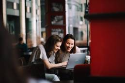 two women in finance working together, hybrid working